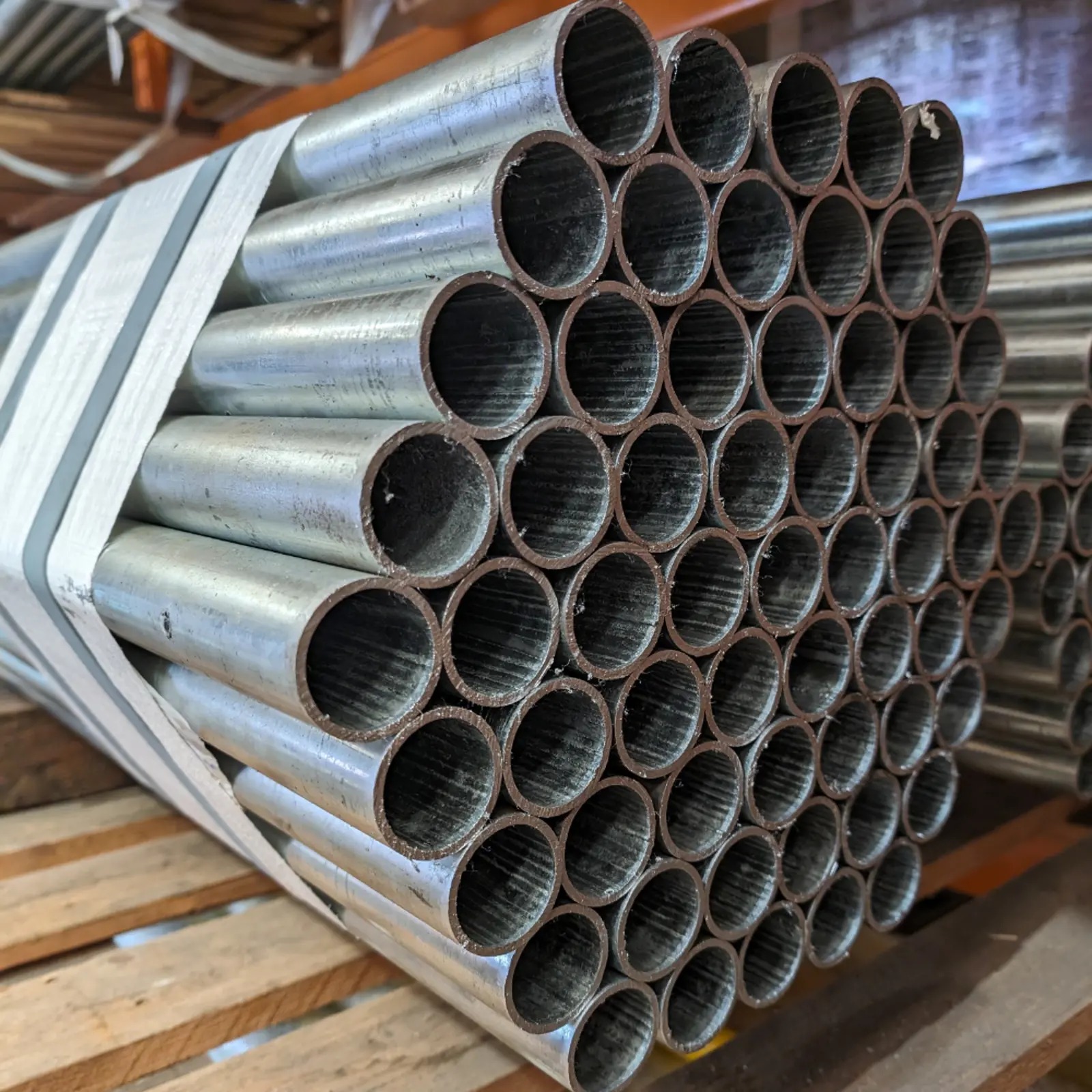 Galvanized steel handrail pipes stacked in warehouse – CoreMet Steel railing and safety tube products