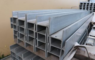 Structural steel universal columns (UC) stacked in warehouse for construction supply